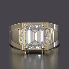 a gold ring with an emerald cut diamond surrounded by small white diamonds on the sides