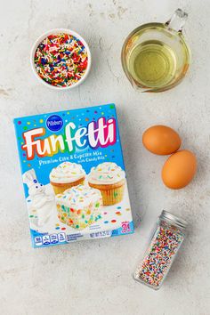 the ingredients to make funfetti are displayed on a white surface with sprinkles