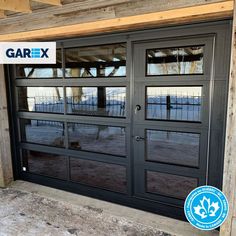 an open garage door with glass on the inside and side windows in front of it