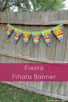 fiesta pinata banner hanging on a fence