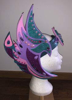 This fantasty-headpiece is based on a Valkyrie-headpiece. For me, the colors are more whimsical. This is made out of PE-foam and embellished with rhinestones and glitterfoam. Whimsical Crown Costume Hat For Carnival, Whimsical Tall Crown Headpiece For Carnival, Mardi Gras Fantasy Crown Costume Headpiece, Fantasy Crown Costume Hat For Mardi Gras, Mardi Gras Fantasy Crown Costume Hat, Adjustable Fantasy Headpieces For Carnival, Fantasy Adjustable Headpieces For Carnival, Fantasy Carnival Headband, Fantasy Headband Headpieces For Carnival