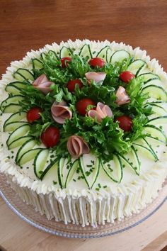 a cake with white frosting and green toppings