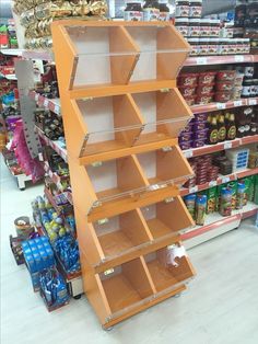 an orange shelf in a store filled with lots of food and drink cans on the shelves