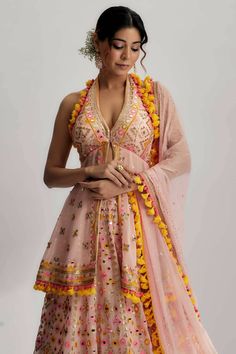 The marya lehenga set is made from a luxurious fabric that drapes gracefully, creating a flattering silhouette. The fabric has a soft and smooth texture, ensuring both comfort and style. It is carefully chosen to enhance the overall look and feel of the lehenga. The highlight of the narya lehenga set is the mesmerizing mirror work. The mirrors are intricately handcrafted and strategically placed to create a dazzling effect. They catch the light and reflect it beautifully, adding a touch of glamo Mirror Work Palazzo Suit, Silk Floor-length Dress With Gota Work, Traditional Drape Silk Dress With Gota Work, Traditional Silk Dress With Gota Work, Silk Dress For Reception And Navratri, Navratri Dresses With Gota Work In Traditional Drape, Navratri Dress With Gota Work, Gota Work Dress For Reception And Navratri, Bollywood Silk Palazzo Set With Unstitched Blouse