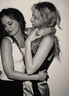 two beautiful young women hugging each other