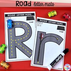 road letter mats with cars and trucks on them