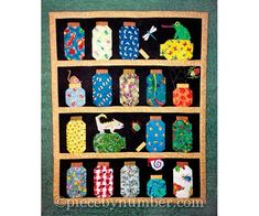 a quilted wall hanging with many different items on it's display shelf,