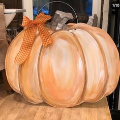 a large pumpkin sitting on top of a wooden table