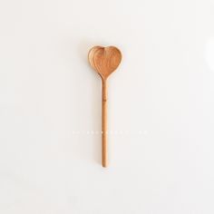 a wooden spoon sitting on top of a white table