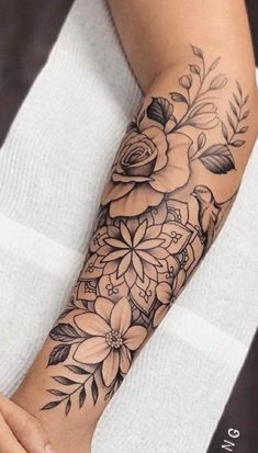 a woman's arm with flowers on it