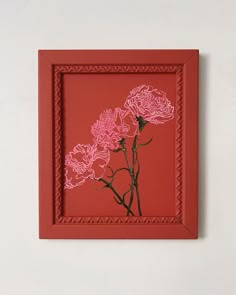 a red frame with some pink flowers on it