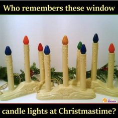 a group of candles sitting next to each other on top of a table with text that reads, who remembers these window candle lights at christmas time?