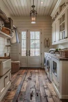 a white washer and dryer sitting in a kitchen next to a door with baskets on it