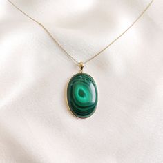 This stunning pendant is set in 14k Solid Yellow Gold with Natural Malachite with utmost precision. It is an unique gemstone pendant for nearly every occasion and is completely hassle-free jewelry. 🔷ABOUT GEMSTONE: Malachite is believed to have protective qualities, shielding the wearer from negative energies and harmful influences. It is thought to act as a shield and help ward off psychic attacks and negativity. Malachite is often associated with transformation and personal growth. It is beli Spiritual Oval Necklace With May Birthstone, Spiritual Oval Necklace For May Birthstone, Green Oval Cabochon Gemstone Necklace, Oval Green Jewelry With Polished Finish, 14k Gold Oval Jewelry With Natural Stones, Green 14k Gold Spiritual Necklace, Spiritual Green 14k Gold Necklace, Oval Green Gemstones In 14k Gold, Elegant Oval Malachite Necklace