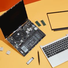 an open laptop computer sitting on top of a desk next to a keyboard and mouse