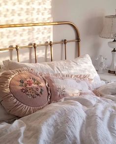 a white bed topped with pillows and blankets