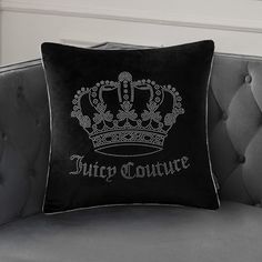 a black and white pillow sitting on top of a couch