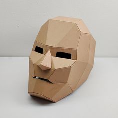 a paper mache mask that looks like a man's face