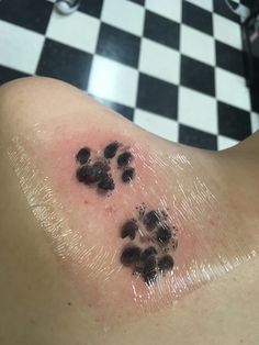 a close up of a person's chest with dog paw prints on the skin