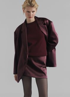 Color: Burgundy Midweight satin fabric Relaxed fit Mini length Concealed back zip closure Lined 100% Polyester Dry Clean By The Frankie Shop. Imported Fitted Satin Bottoms For Fall, Satin Skirt For Fall Evening, Satin Skirt For Evening In Fall, Fall Evening Satin Skirt, Winter Party Satin Outerwear, Solid Satin Skirt For Workwear, Chic Satin Skirt For Fall, Fitted Satin Outerwear For Night Out, Fall Party Outerwear In Satin