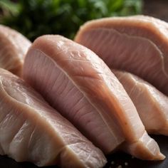 raw fish fillets on a cutting board with parsley in the backgroud