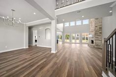 an empty living room with hard wood floors