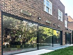 an outside view of a brick building with glass walls