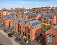 a group of houses with solar panels on the roof