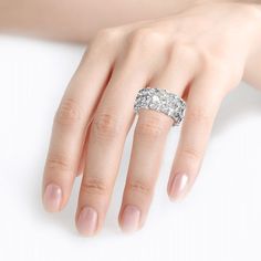 a woman's hand with a diamond ring on it