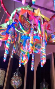 a chandelier made out of lollipops is hanging from the ceiling