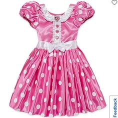 a pink dress with white polka dots on it