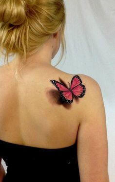 a woman with a pink butterfly tattoo on her back shoulder