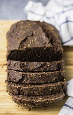 a loaf of chocolate bread sitting on top of a wooden cutting board