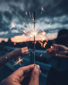 someone is holding a sparkler in their hand