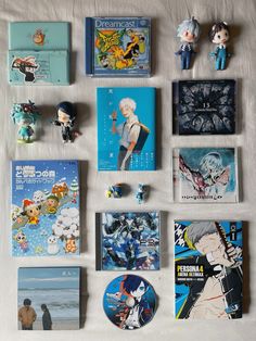 various anime brochures are laid out on a bed