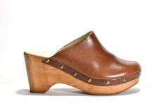 Retro clog on authentic wooded bottom.  Leather lined, rubber outsole.MEASUREMENTS: Heel Height: 3.25 in. Weight: 13 oz. Platform Height: 1.75 in Spring Slip-on Clogs With Rubber Heel Cap, Leather Clogs With Wooden Heel And Almond Toe, Wooden Mules With Rubber Sole And Round Toe, Casual Wood Mules With Round Toe, Natural Clogs With Leather Sole For Spring, Natural Leather Sole Clogs For Spring, Brown Mules With Wooden Heel And Almond Toe, Brown Leather Mules With Rubber Heel Cap, Natural Wood Round Toe Clogs