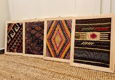 four pieces of woven art on display in a room with white walls and flooring