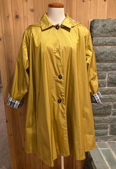 Vintage Mustard Yellow Knee-Length Raincoat, Gallery, Size 4 mustard yellow raincoat with detachable hood  sparkly black and white plaid patterned cuffs and hood lining single-breasted 4 buttons to close zipper in coat for extra liner (liner not included) sewn-in shoulder pads Label:  Gallery Material: no fabric label, feels like nylon Condition: great - no stains or tears, but there are two missing buttons (one on front and other on right cuff) Measurements (flat across, please double where app Yellow Raincoat, Fabric Labels, Black And White Plaid, Detachable Hood, White Plaid, Mustard Yellow, Plaid Pattern, Shoulder Pads, Mustard