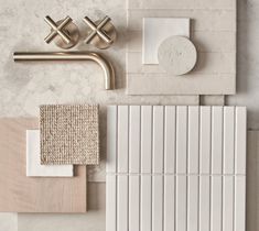 white tile and accessories laid out on top of each other, including a sink faucet