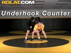 two men standing on top of a wrestling ring with the words kolat com underhok counter