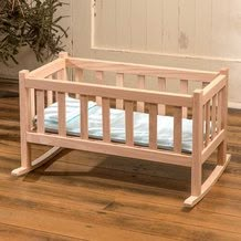 a small wooden crib sitting on top of a hard wood floor