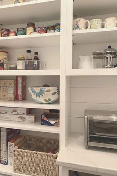 the shelves in this kitchen are full of food