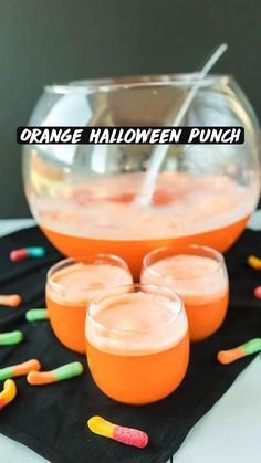 orange halloween punch in glasses with candy sticks on the side and text overlay that reads orange halloween punch