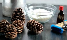 pine cones, salt and pepper shakers are sitting on a table next to a glass bowl