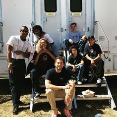 a group of people sitting in front of a trailer