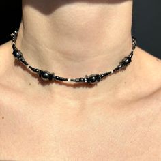 Handmade necklace made from natural hematite and synthetic cat's eye stone. This dark gray choker features glossy beads of hematite in various shapes and beads of cat's eye, completed with a stainless steel chain extender and closure. Thanks to the adjustable chain, the necklace can be worn higher or lower. If you need a different length for the accessory, please write to me about it. DIMENSIONS & FEATURES: ▪️ Materials: natural hematite stone, synthetic cat's eye stone, stainless steel (hypoallergenic and maintains its appearance over time) ▪️ Length: 35+10(chain extenders)=45 cm / 13,7+4(chain extenders)=17,7 inch ▪️ Color: dark gray ▪️ Weight: 23g / 0,8 oz PACKAGE & SHIPPING: ▪️ ECO-friendly packing. I draw inspiration from nature and strive to minimize environmental impact. ▪️ FREE shi Dark Beaded Necklace, Adjustable Hematite Necklace With Black Beads, Adjustable Beaded Hematite Necklaces, Adjustable Hematite Beaded Necklaces, Adjustable Hematite Beaded Necklace, Cat Eye Necklace, Linen Pouch, Galaxy Necklace, Choker Handmade