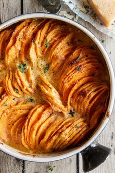 baked potatoes in a white casserole dish with parsley on top