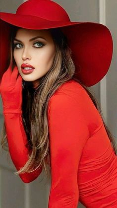 a beautiful woman wearing a red hat and dress