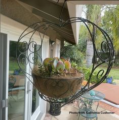 a heart shaped planter filled with succulents on top of a patio