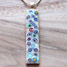 "These unique rectangle shaped pendants have been hand-crafted with genuine Italian Millefiori glass, where beautiful glass has been produced for centuries. The glass is set in a silver tray and sealed with high quality resin to produce an one of a kind pendant. Design: Italian Millefiori Glass Colour: Multiple Pendant Size: 5 x 1.5cm Chain Length: Choice of 16\" - 22\" silver plated snake chain" Handmade Rectangular Glass Jewelry, Modern Rectangular Glass Jewelry, Rectangular Glass Jewelry Gift, Rectangular Glass Jewelry For Gifts, Handmade Clear Rectangular Jewelry, Quartz Crystal Necklace, Rose Quartz Pendant, Pendant Design, Quartz Pendant